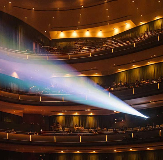 A beam of light crossing the auditorium of the Esplanade Concert Hall